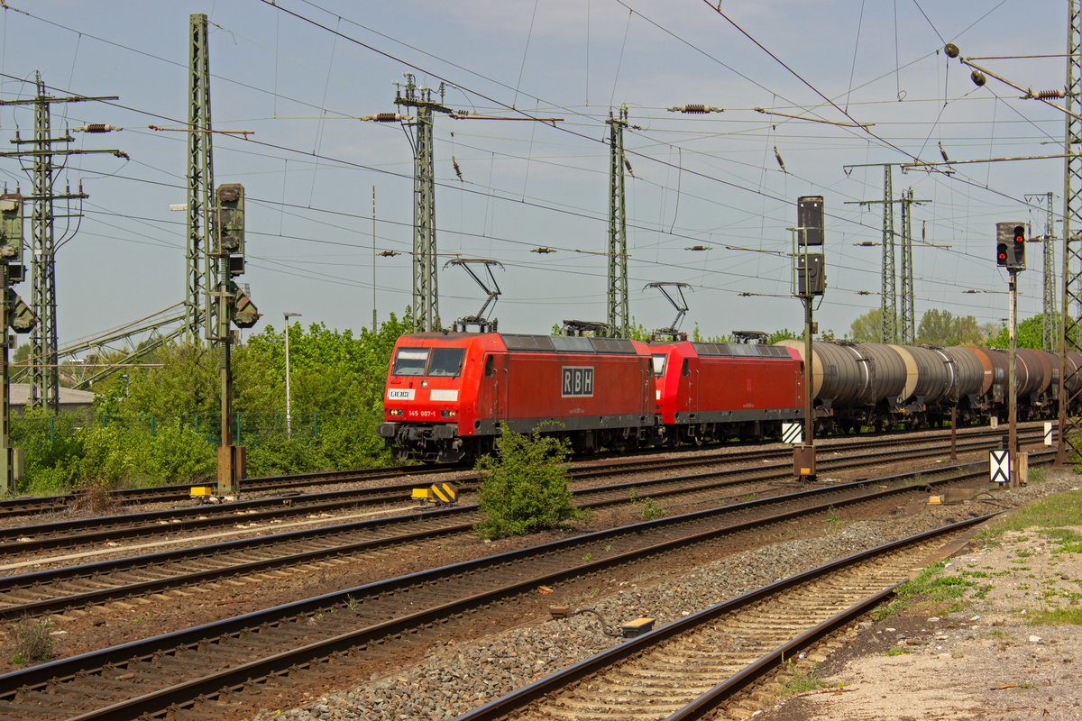 145 007 und 026 geh�ren zu den von DB Cargo an RBH vermieteten Lokomotiven dieser Baureihe, die dort die ebenfalls ehemaligen DB-Loks der Baureihe 143 abl�sen. Am 24.04.19 durchfahren beide gemeinsam den Bahnhof von Hamm, wobei nur 145 007 bereits als RBH-Lok zu identifizieren ist.