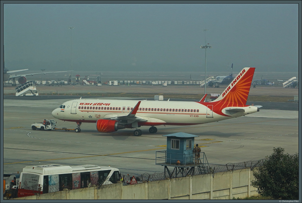 Die A320-214 VT-EXD der Air India steht am 27.12.2019 auf dem Vorfeld des Flughafens Dehli  Indira Gandhi . Der Smog lässt hier nur eine geringe Sicht zu.